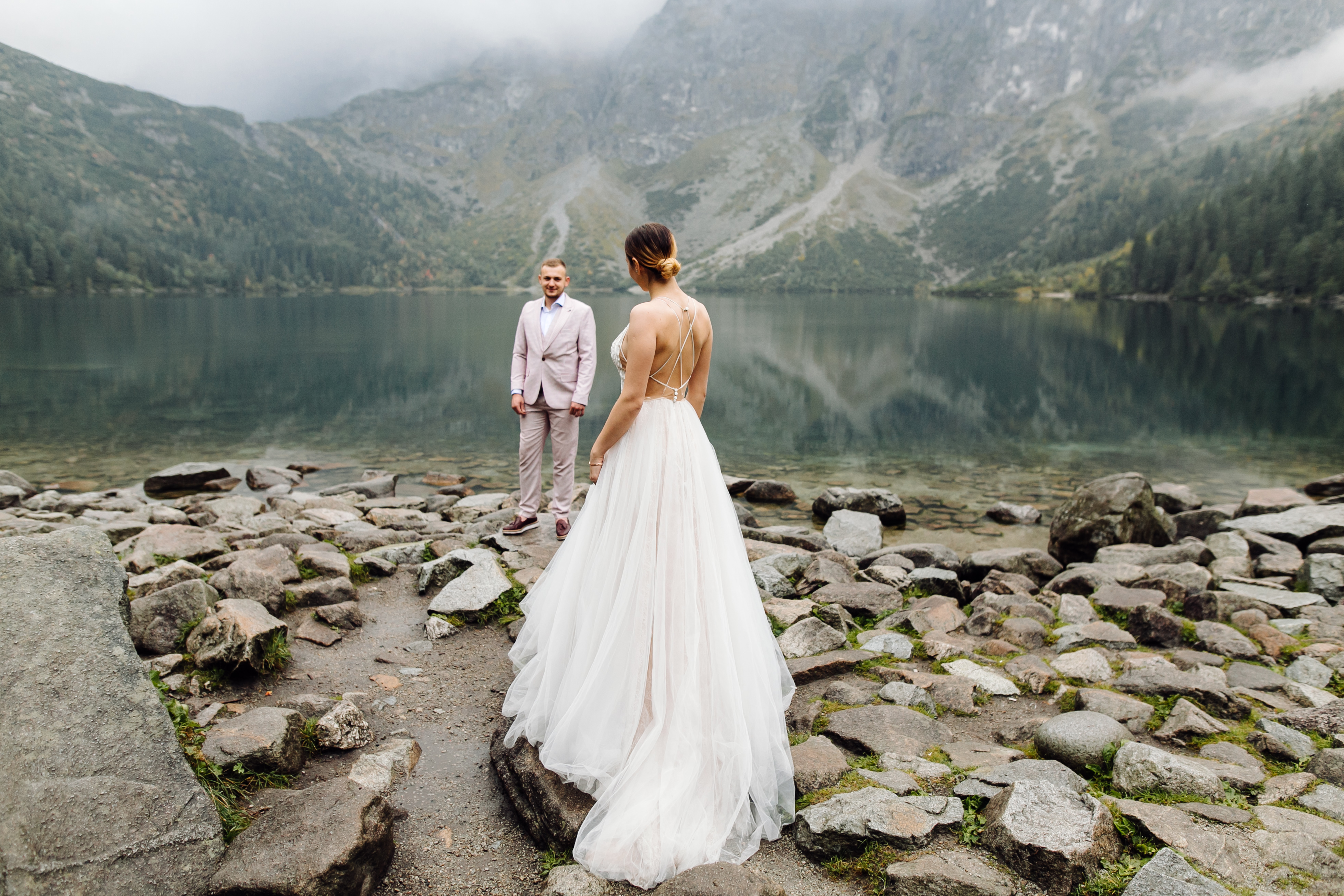 romantic-wedding-couple-in-love-standing-of-the-sea-eye-lake-in-poland-tatra-mountains